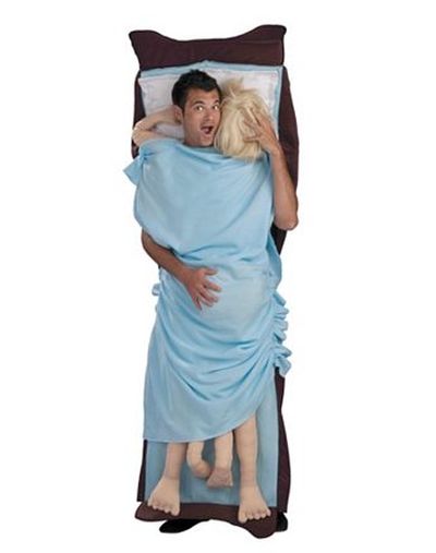 Funny Halloween costume in bed with woman