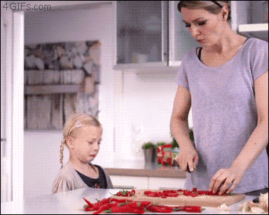 Mum cutting peppers in the kitchen funny gif at PMSLweb.com
