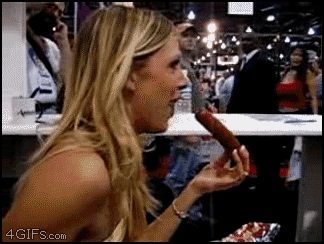 Man watching woman fit an entire sausage into her mouth funny adult gif